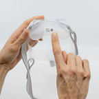Hand adjusting a n Airfit F30i cushion on a light gray background