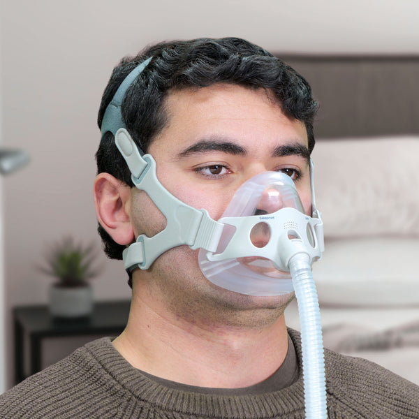 Person wearing a CPAP mask in a home setting