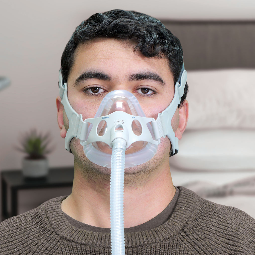Man wearing a CPAP mask in a room setting