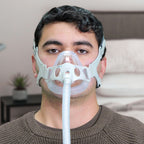 Man wearing a CPAP mask in a room setting