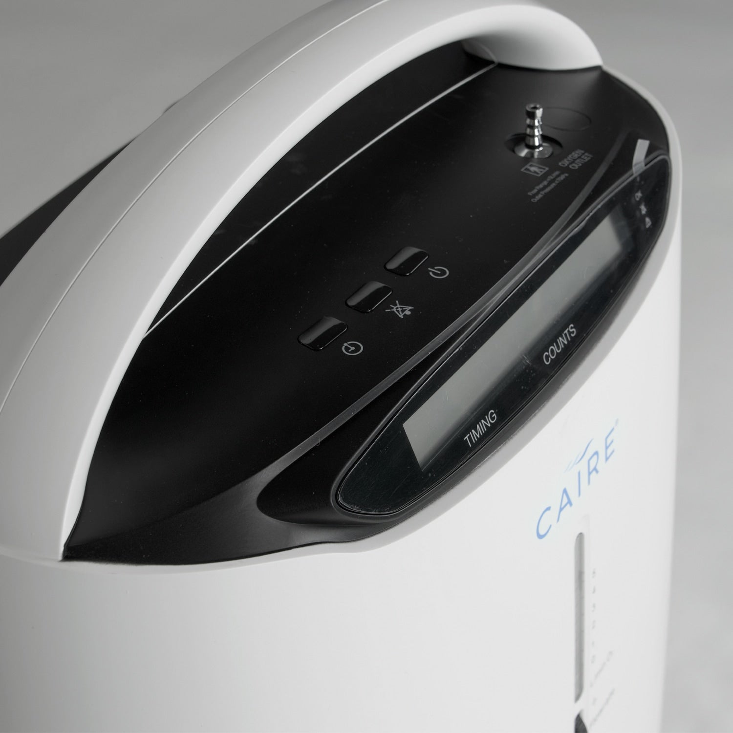 Close-up of a Caire oxygen concentrator with control panel and brand name.