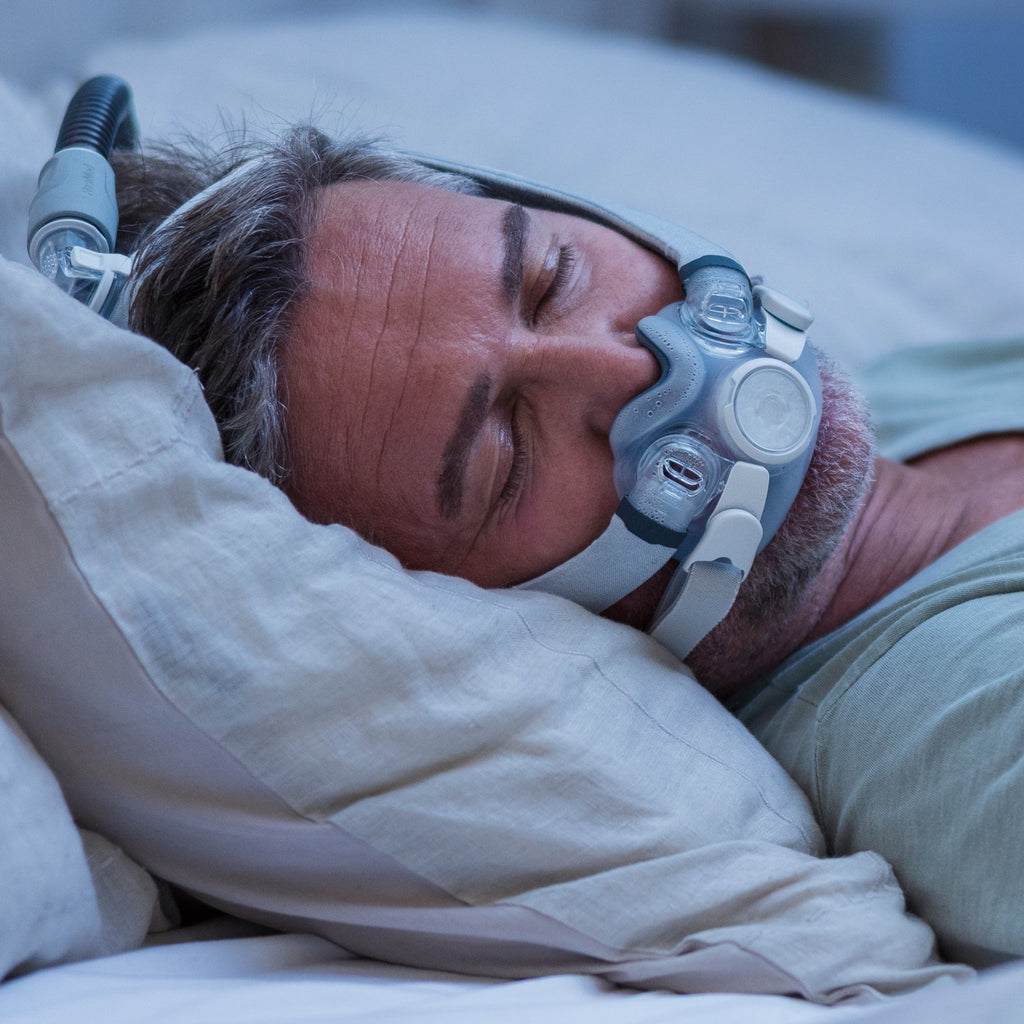 Man wearing a CPAP mask while sleeping