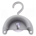 Gray plastic hook with a suction cup on a white background
