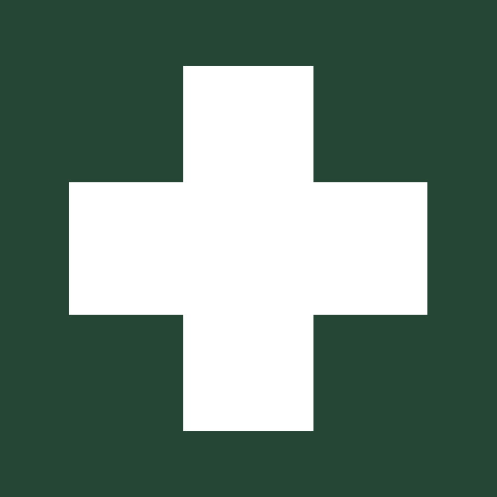 White cross symbol on a green background