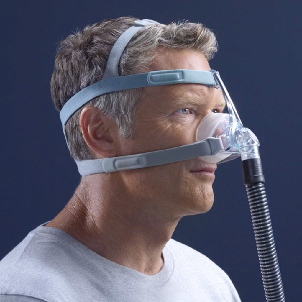 Man wearing an Eson 2 CPAP mask with a blue background
