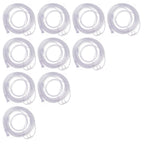Ten clear plastic replacement tubing pieces, coiled and arranged in a staggered layout on a plain white background.