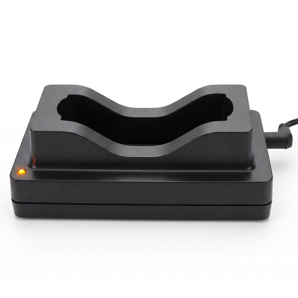 A black plastic dual-device charging dock with a curved recessed slot, featuring a small orange indicator light on the left and a power cord extending from the right, shown on a white background.