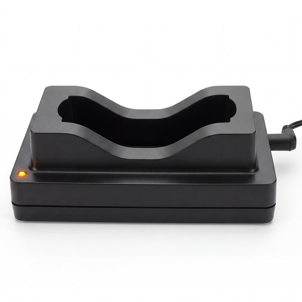 A black plastic dual-device charging dock with a curved recessed slot, featuring a small orange indicator light on the left and a power cord extending from the right, shown on a white background.