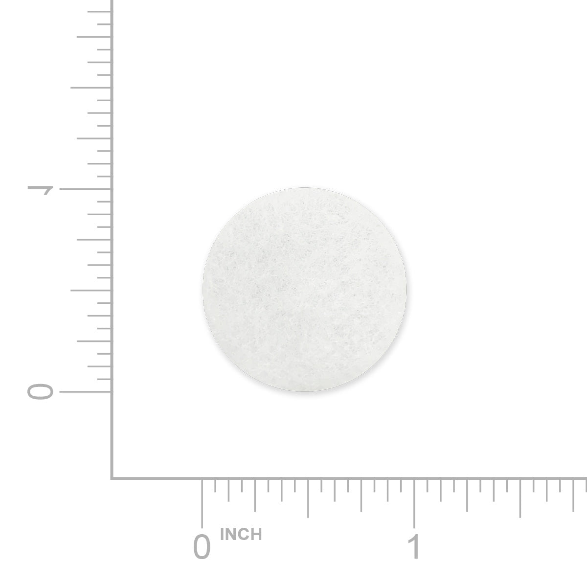 White round luna travel CPAP filter with a ruler for scale on a white background