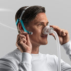 Man Adjusting Nova Nasal Mask Headgear