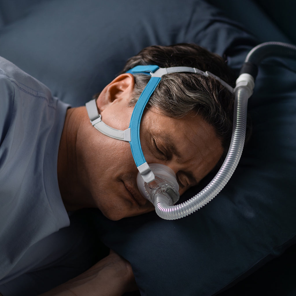 Man wearing a CPAP mask while sleeping