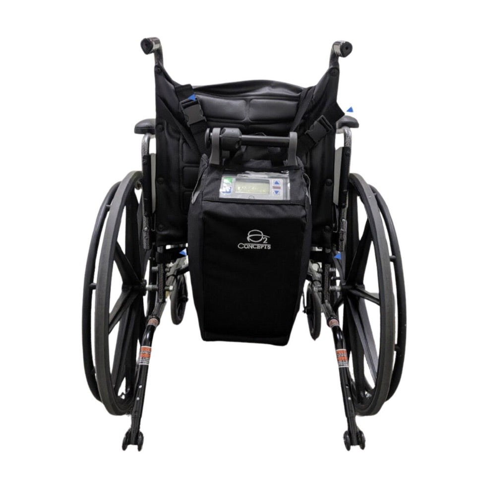 Rear view of a wheelchair with an Oxlife Independence concentrator in a bag hanging on it 