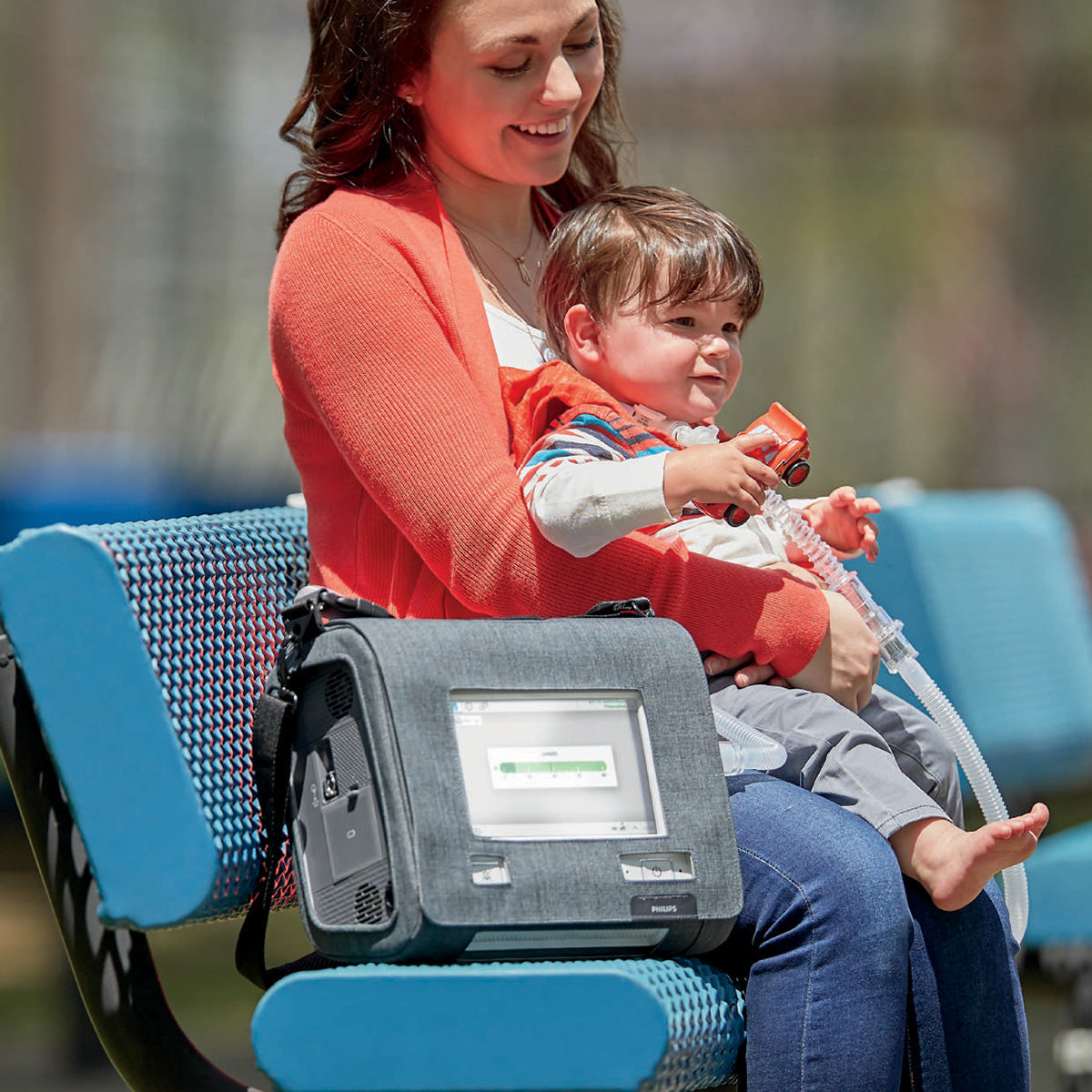 Lady on bench with child and Trilogy Evo in use 
