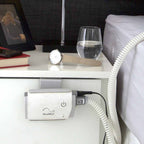 resmed airmini cpap hanging on drawer