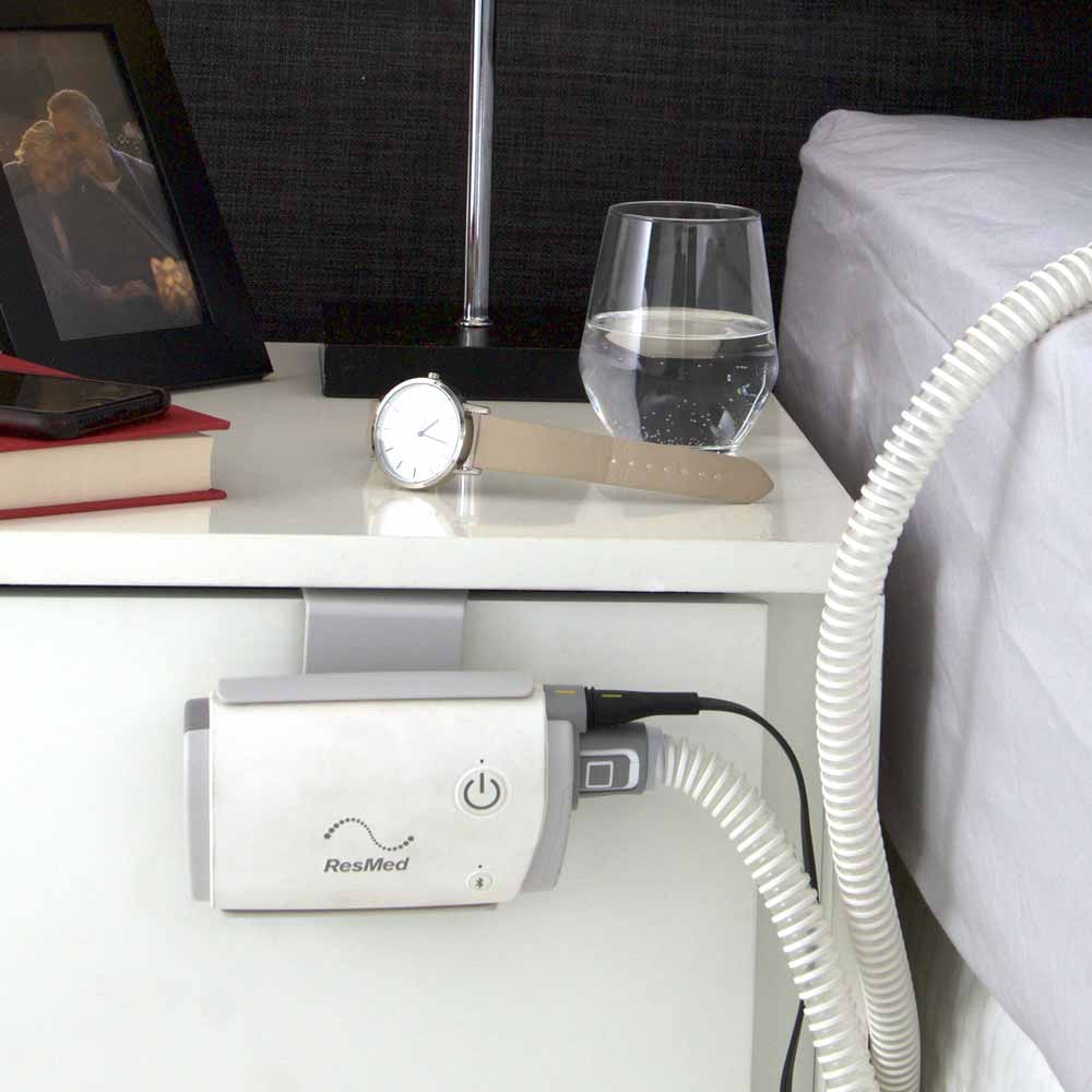 resmed airmini cpap hanging on drawer