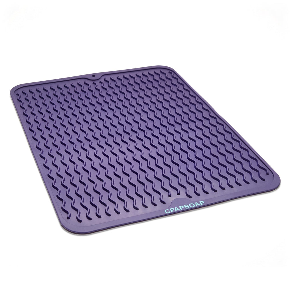 Purple silicone mat with textured surface on a light purple background