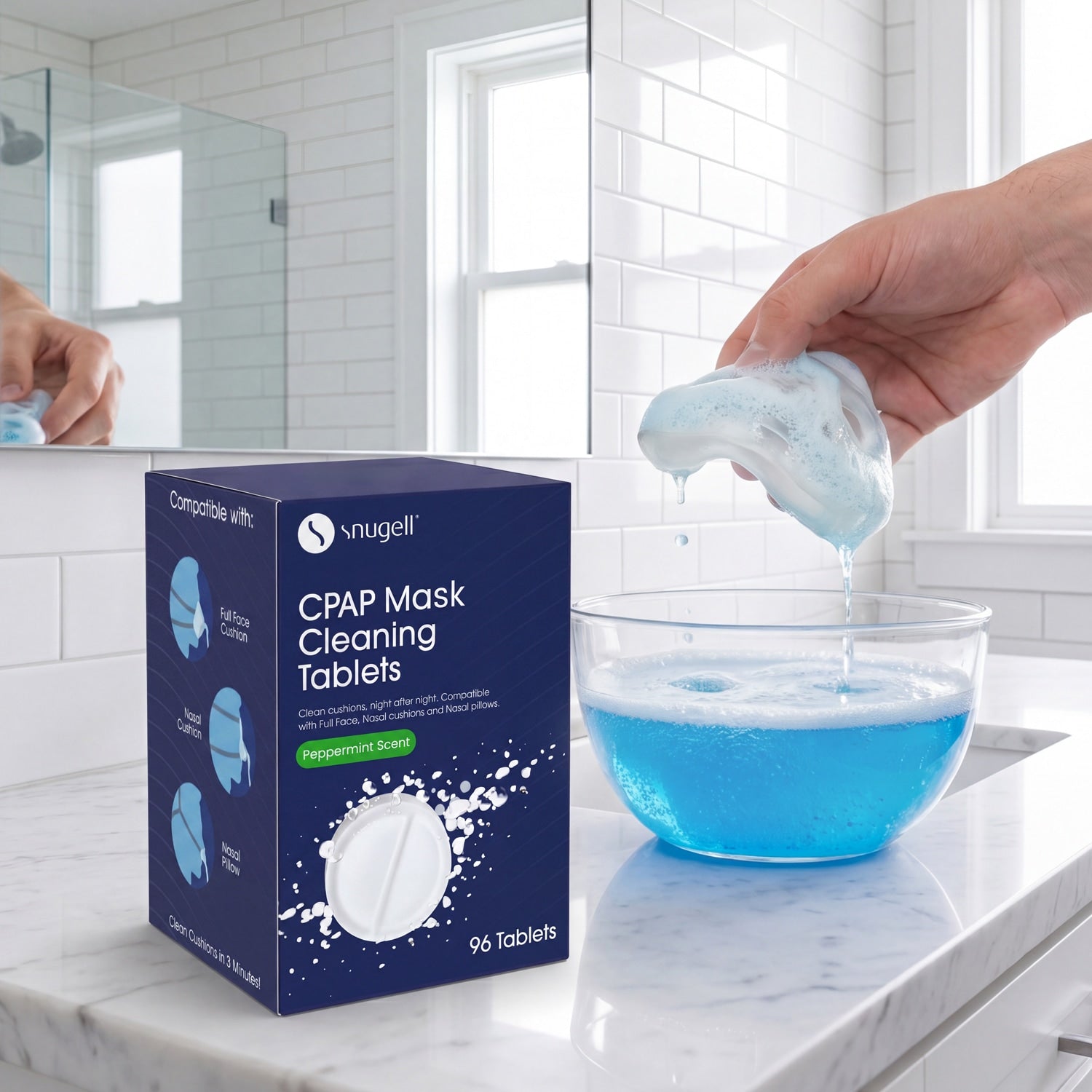 Snuggll CPAP Mask Cleaning Tablets packaging with a hand holding a tablet over a bowl of blue liquid in a bathroom setting.