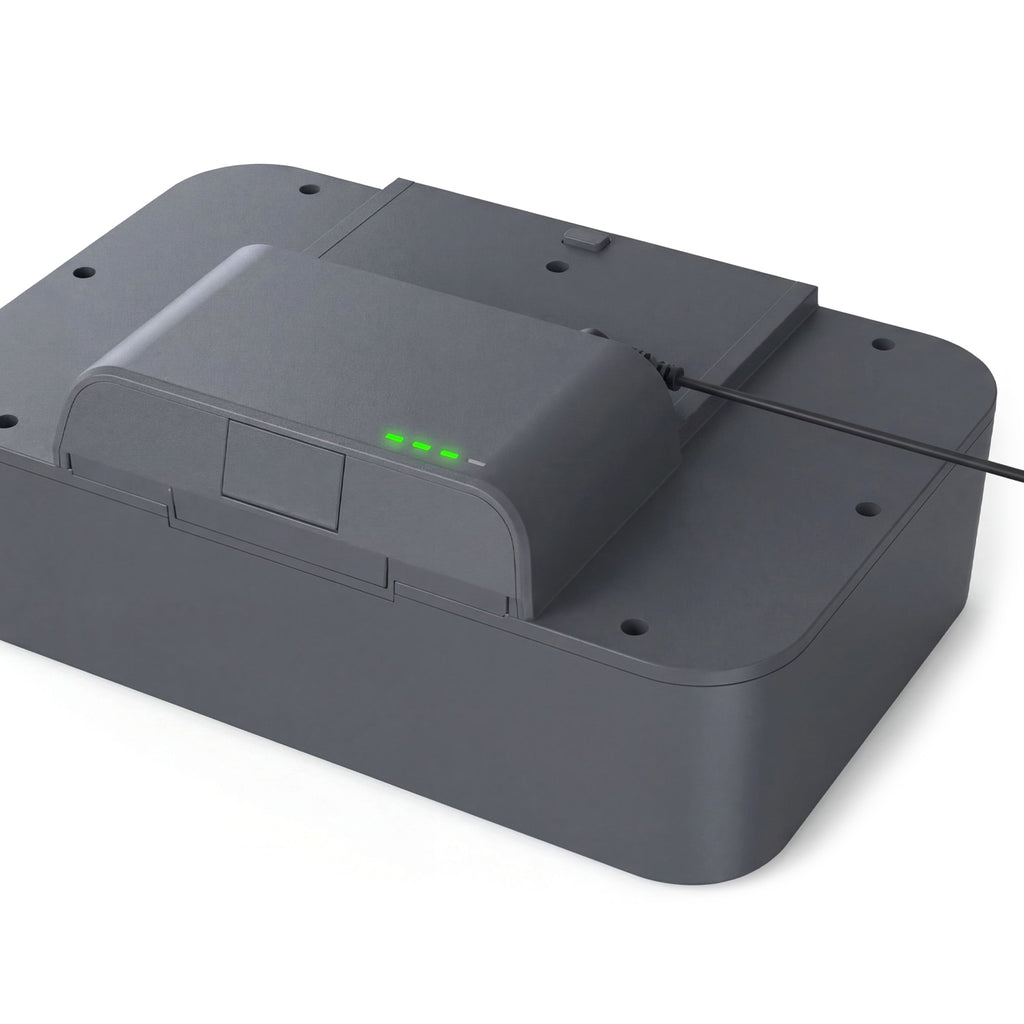 Gray electronic device with a charging dock on a white background