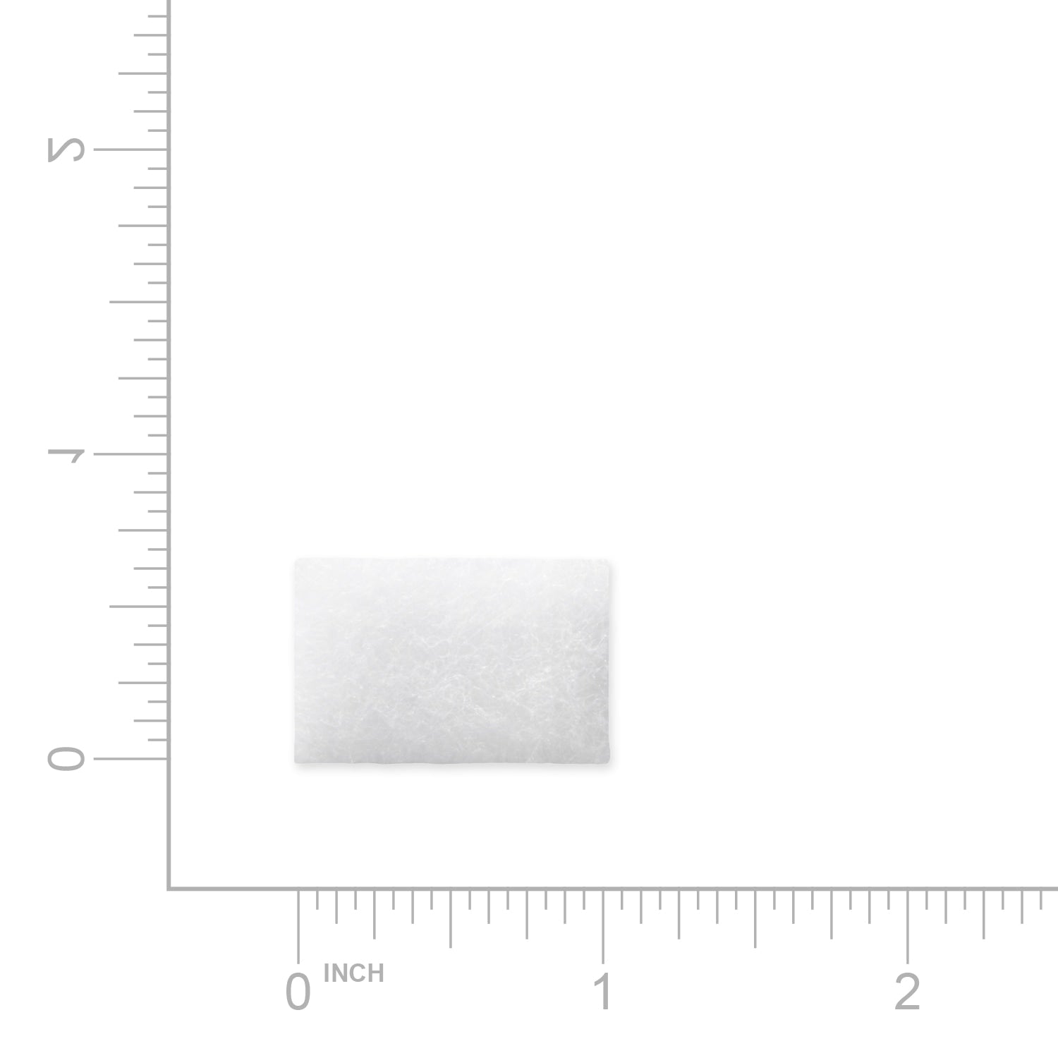 White filter with textured surface on a white background with measurement scale