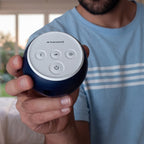 Man holding a Transcend Micro in a cozy indoor setting.