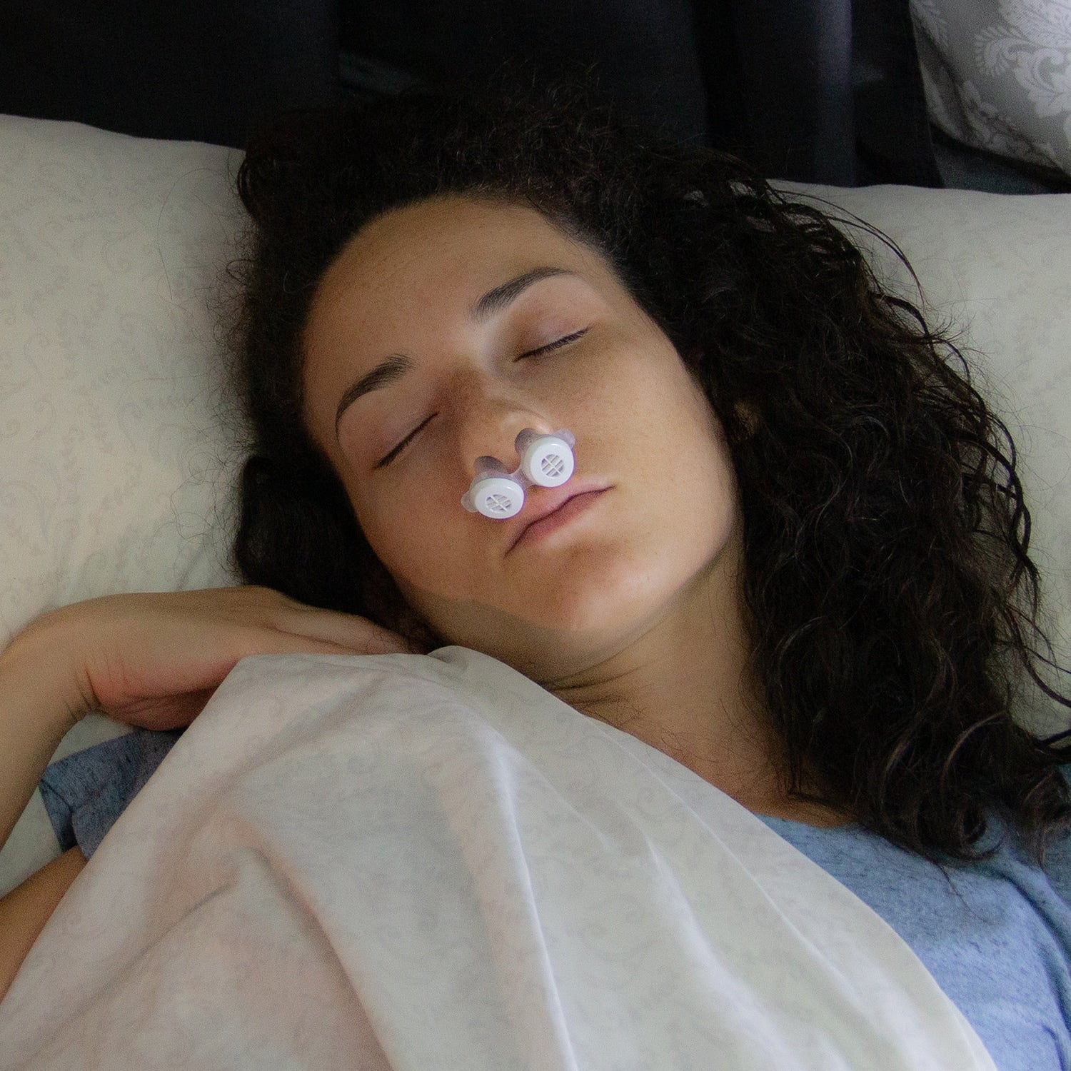 Woman sleeping while wearing Bongo RX EPAP Therapy Device