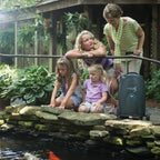 Woman and two children by a pond with an Eclipse oxygenator in the foreground.